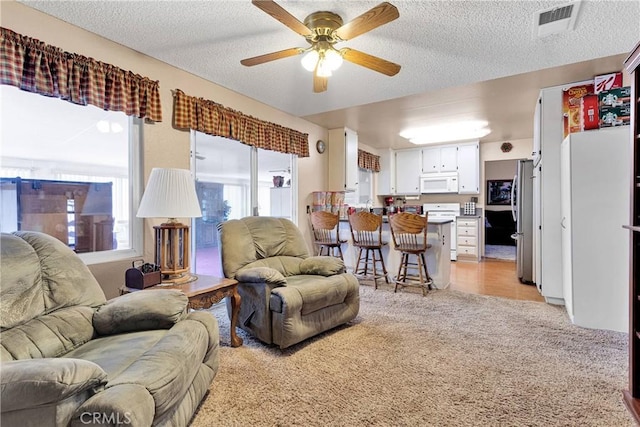 15199 Farmington Ct, Hesperia, CA 92345 - living area featuring light colored carpet, a ceiling fan, and a textured ceiling