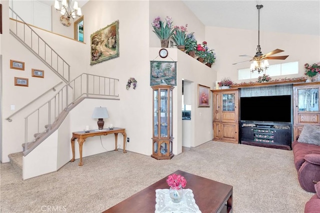 15199 Farmington Ct, Hesperia, CA 92345 - carpeted living room with high vaulted ceiling, stairs, ceiling fan, and a chandelier