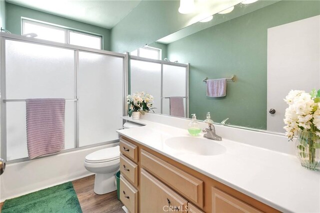 15199 Farmington Ct, Hesperia, CA 92345 - full bath with vanity, toilet, combined bath / shower with glass door, and wood finished floors