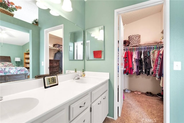 15199 Farmington Ct, Hesperia, CA 92345 - bathroom featuring double vanity, a spacious closet, and ensuite bathroom