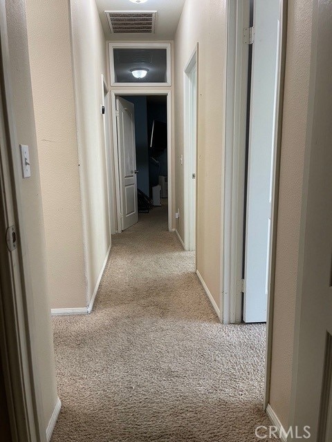 124 Lighthouse Ct, San Jacinto, CA 92583 - hallway featuring carpet and baseboards
