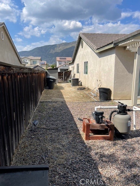 124 Lighthouse Ct, San Jacinto, CA 92583 - fenced backyard with a mountain view and central air condition unit