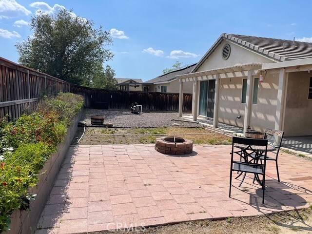 124 Lighthouse Ct, San Jacinto, CA 92583 - view of patio with a fire pit, a fenced backyard, and a pergola