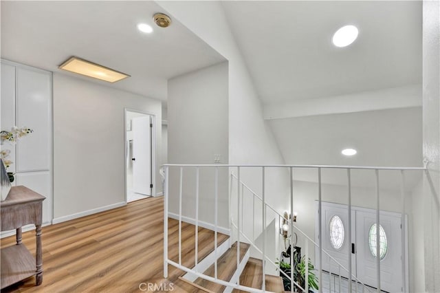 foyer with light wood finished floors, baseboards, and recessed lighting
