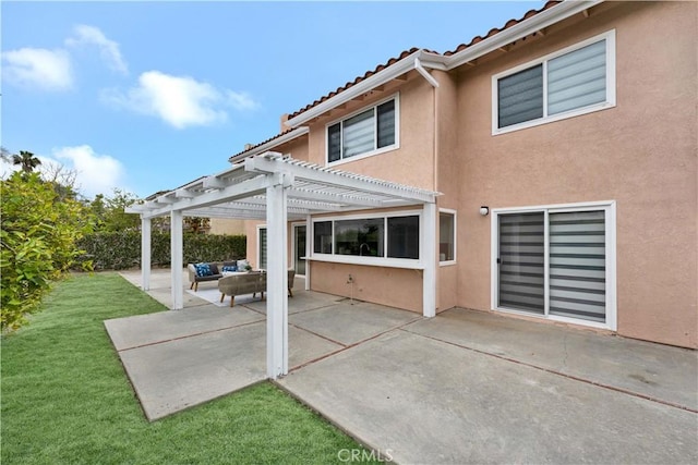 back of house featuring a pergola, stucco siding, a patio area, a lawn, and an outdoor hangout area