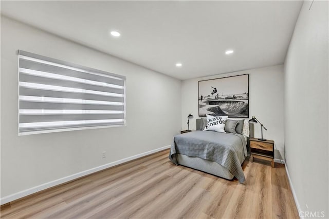 bedroom featuring wood finished floors, baseboards, and recessed lighting