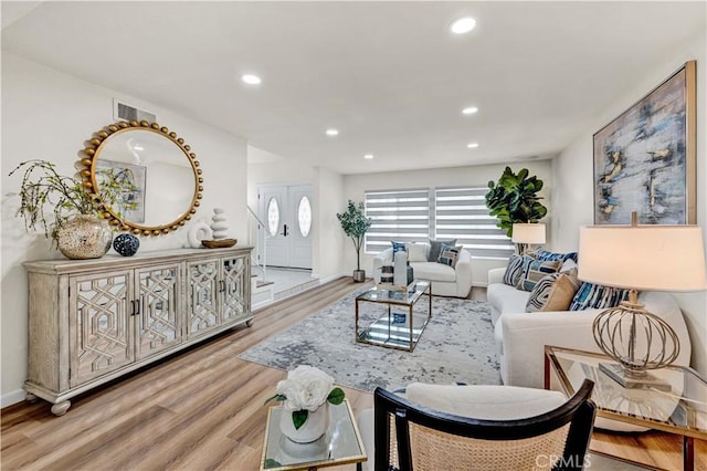 living area featuring wood finished floors, recessed lighting, and baseboards