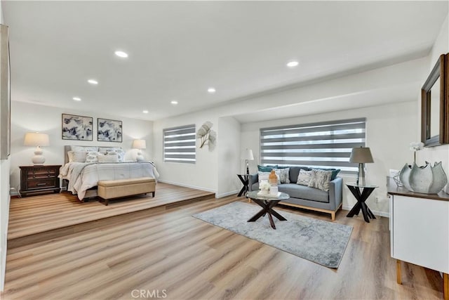 bedroom with light wood finished floors, recessed lighting, and baseboards