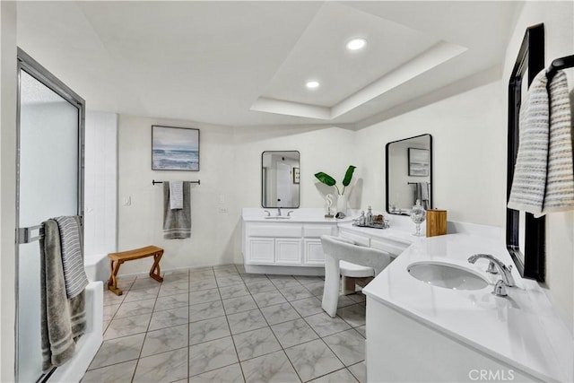 full bath featuring marble look tile flooring, two vanities, recessed lighting, a raised ceiling, and an enclosed shower