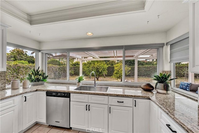 kitchen featuring stainless steel dishwasher, a sink, white cabinets, light stone counters, and ornamental molding