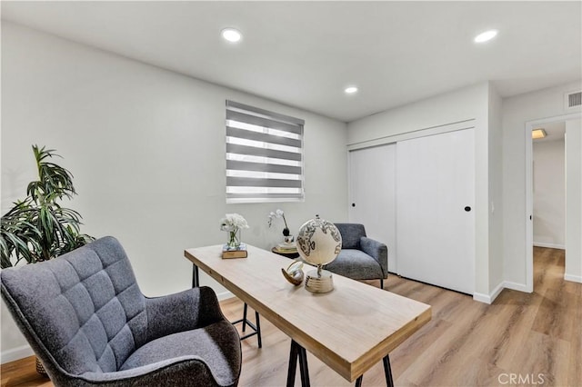 office space with light wood-style floors, recessed lighting, and baseboards