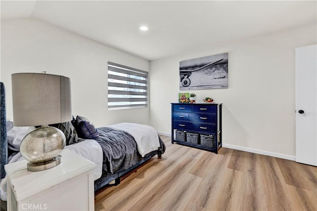 bedroom with wood finished floors, baseboards, recessed lighting, and vaulted ceiling