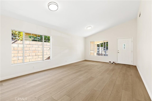 823 E 3rd St, Pomona, CA 91766 - spare room featuring healthy amount of natural light, light wood finished floors, lofted ceiling, and baseboards