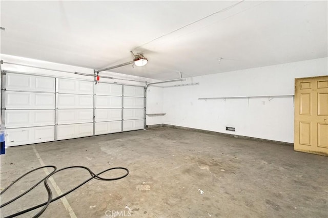 823 E 3rd St, Pomona, CA 91766 - garage with a garage door opener and baseboards