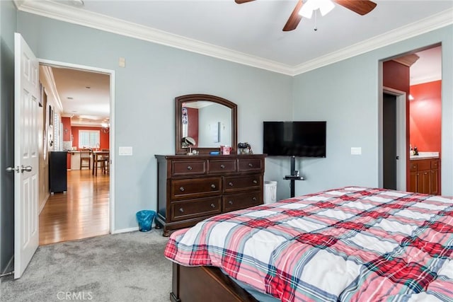 bedroom with ornamental molding, carpet, baseboards, and ceiling fan