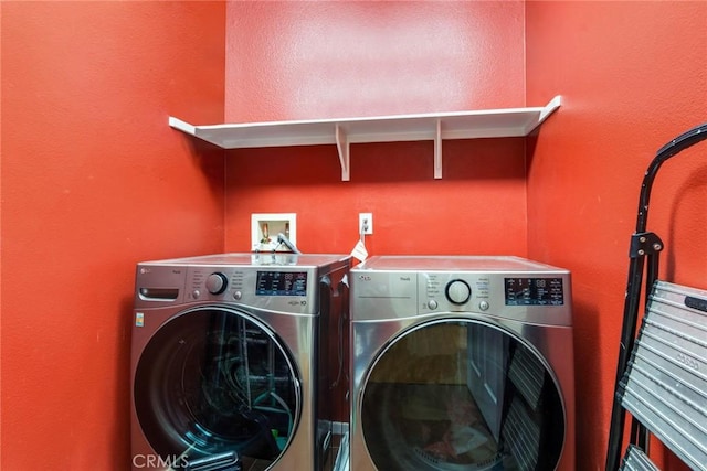 laundry room with washing machine and dryer