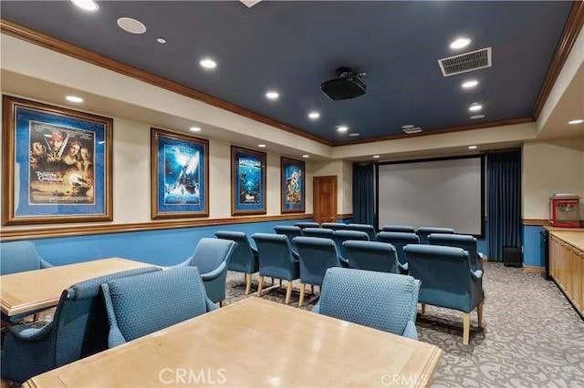 home theater room featuring ornamental molding, light carpet, a raised ceiling, recessed lighting, and baseboards