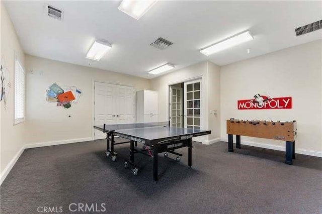 rec room featuring baseboards and dark carpet