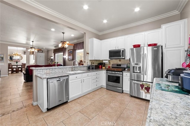 19536 Cherrydale Ct, Apple Valley, CA 92308 - kitchen with stainless steel appliances, a sink, a peninsula, ornamental molding, and ceiling fan