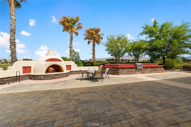 19536 Cherrydale Ct, Apple Valley, CA 92308 - view of patio / terrace featuring an outdoor stone fireplace and area for grilling