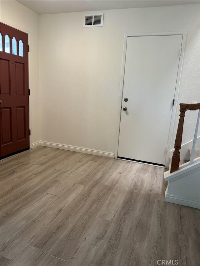 entryway with wood finished floors and baseboards