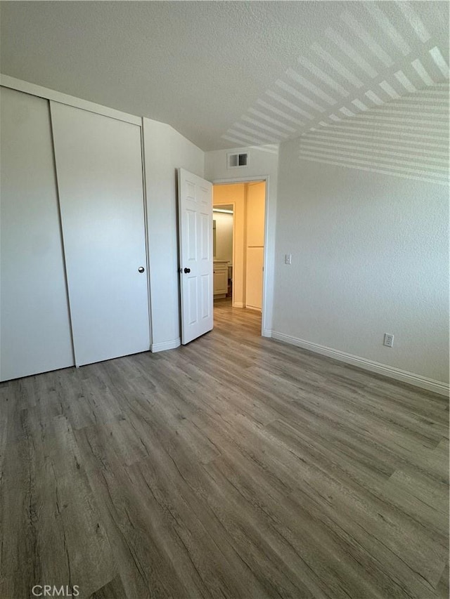 2801 Woodview Ct, Walnut, CA 91789 - unfurnished bedroom with wood finished floors, a closet, and a textured ceiling