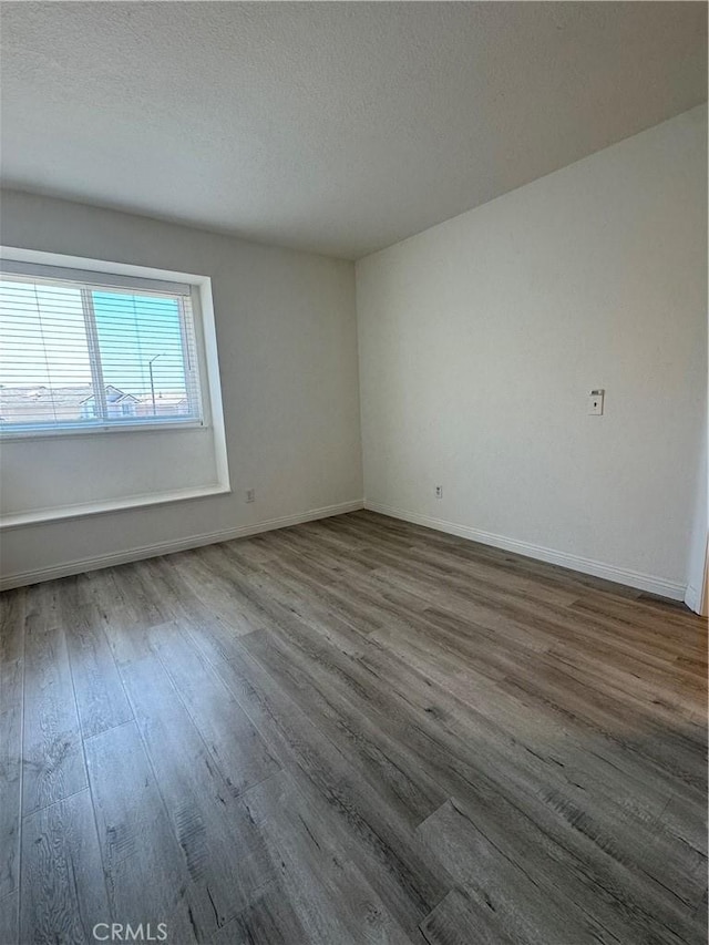 2801 Woodview Ct, Walnut, CA 91789 - spare room featuring dark wood finished floors and a textured ceiling