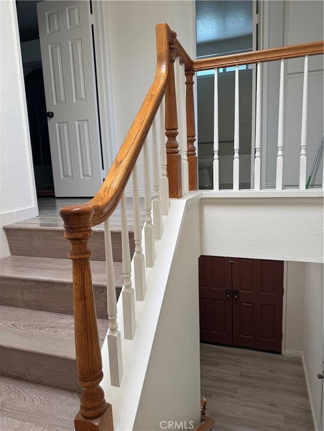 stairway featuring wood finished floors