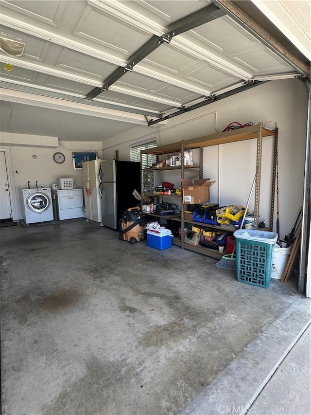 garage with washer and clothes dryer and freestanding refrigerator