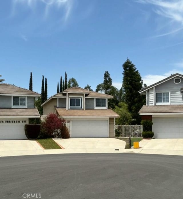 view of front facade featuring concrete driveway and an attached garage