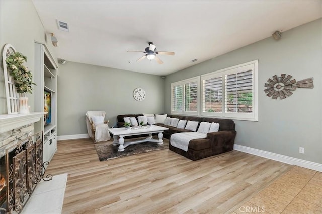 1232 Tucson Ave, Norco, CA 92860 - living room with a ceiling fan, baseboards, light wood finished floors, and a warm lit fireplace