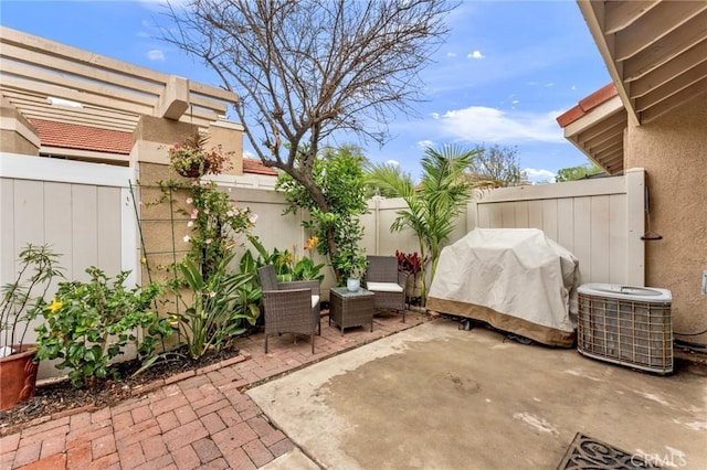 view of patio with central AC unit and a fenced backyard