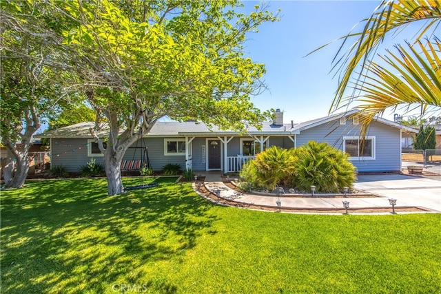 ranch-style house with a front lawn, covered porch, and a chimney