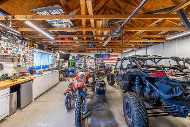 garage featuring a workshop area and fridge