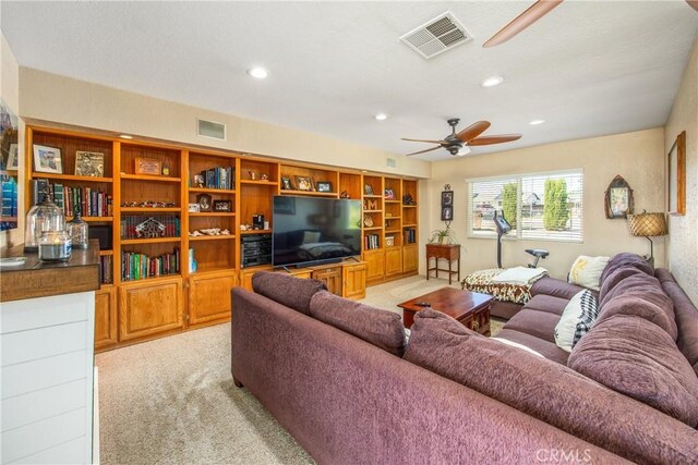 living room featuring light colored carpet, ceiling fan, and recessed lighting