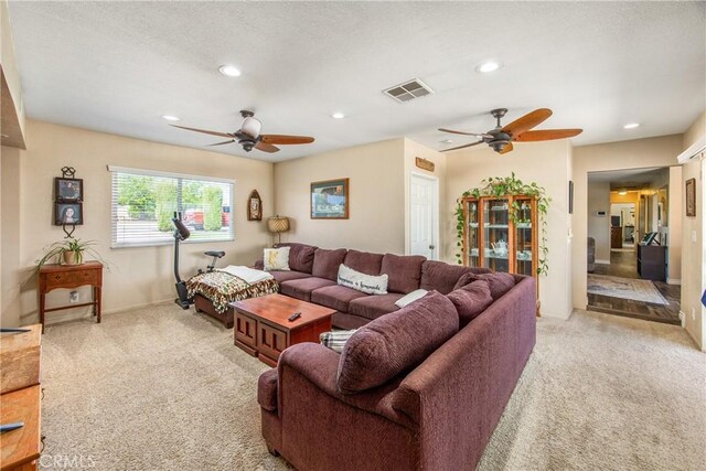 living area with a ceiling fan, light colored carpet, and recessed lighting