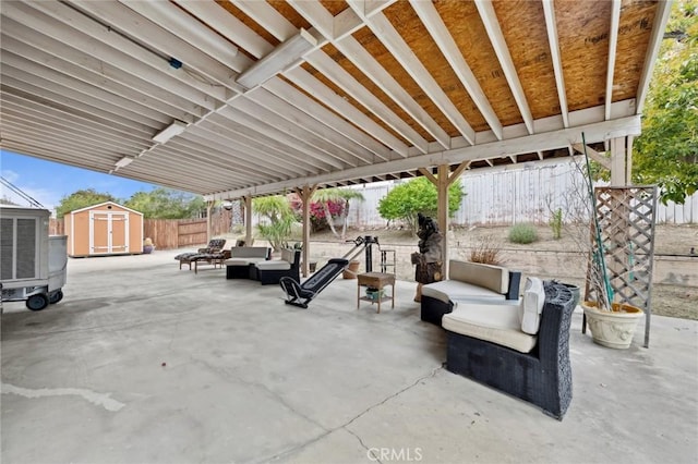 view of patio featuring an outdoor living space, a shed, an outdoor structure, and a fenced backyard