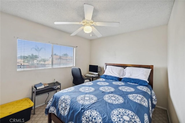 bedroom with a textured ceiling and a ceiling fan