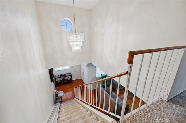 stairs with a chandelier