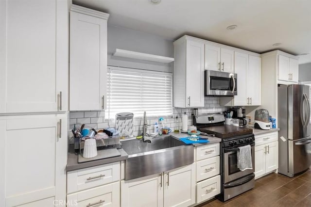 4034 Durfee Ave, Pico Rivera, CA 90660 - kitchen featuring appliances with stainless steel finishes, a sink, decorative backsplash, and white cabinets