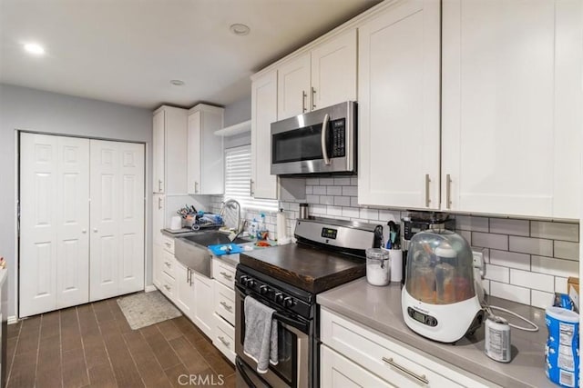 4034 Durfee Ave, Pico Rivera, CA 90660 - kitchen with stainless steel appliances, white cabinets, backsplash, a sink, and recessed lighting