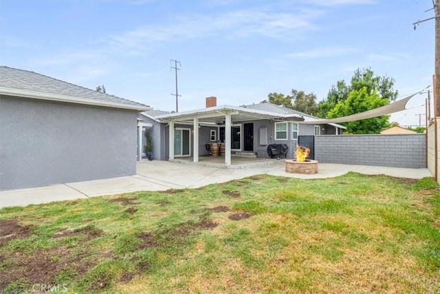 4034 Durfee Ave, Pico Rivera, CA 90660 - back of house featuring an outdoor fire pit, a patio area, and stucco siding