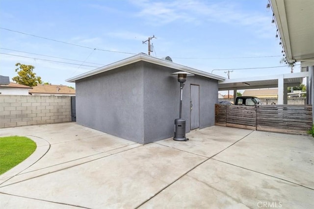 back of house featuring a patio area, fence, and stucco siding