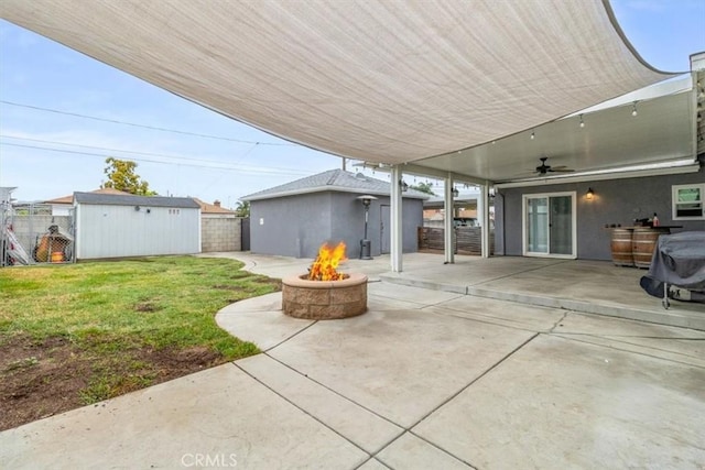 4034 Durfee Ave, Pico Rivera, CA 90660 - view of patio featuring an outdoor fire pit, ceiling fan, an outbuilding, and a storage shed
