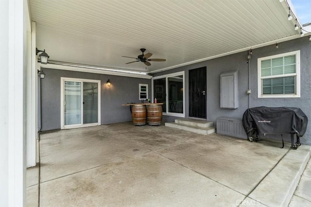 view of patio with a ceiling fan, entry steps, and a grill