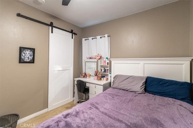 4034 Durfee Ave, Pico Rivera, CA 90660 - carpeted bedroom with a barn door, baseboards, and a ceiling fan