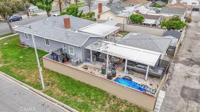 aerial perspective of suburban area featuring a pool