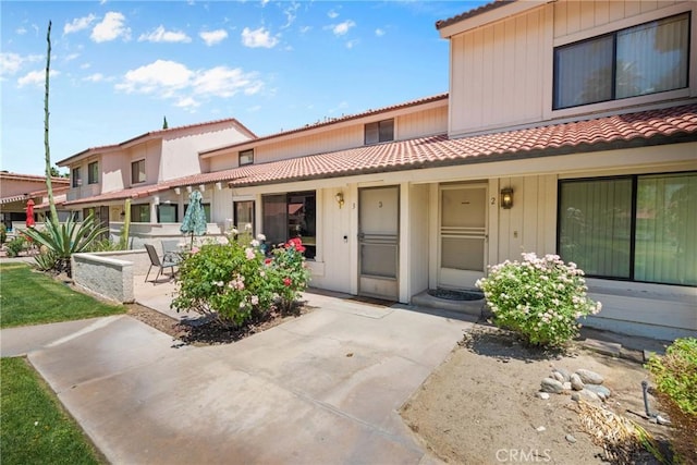6134 Arroyo Rd Unit 3, Palm Springs, CA 92264 - view of front of property with a tiled roof and a patio area