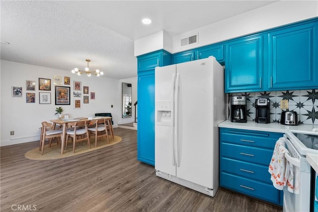 6134 Arroyo Rd Unit 3, Palm Springs, CA 92264 - kitchen with white appliances, blue cabinetry, dark wood finished floors, a chandelier, and light countertops