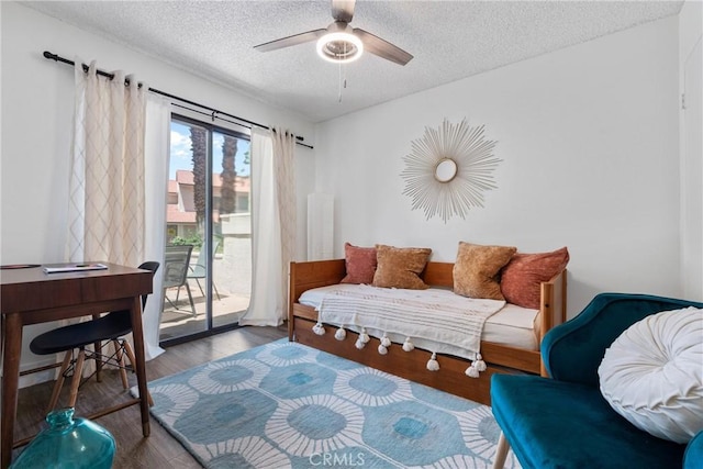 6134 Arroyo Rd Unit 3, Palm Springs, CA 92264 - bedroom with access to outside, a textured ceiling, wood finished floors, a desk, and ceiling fan